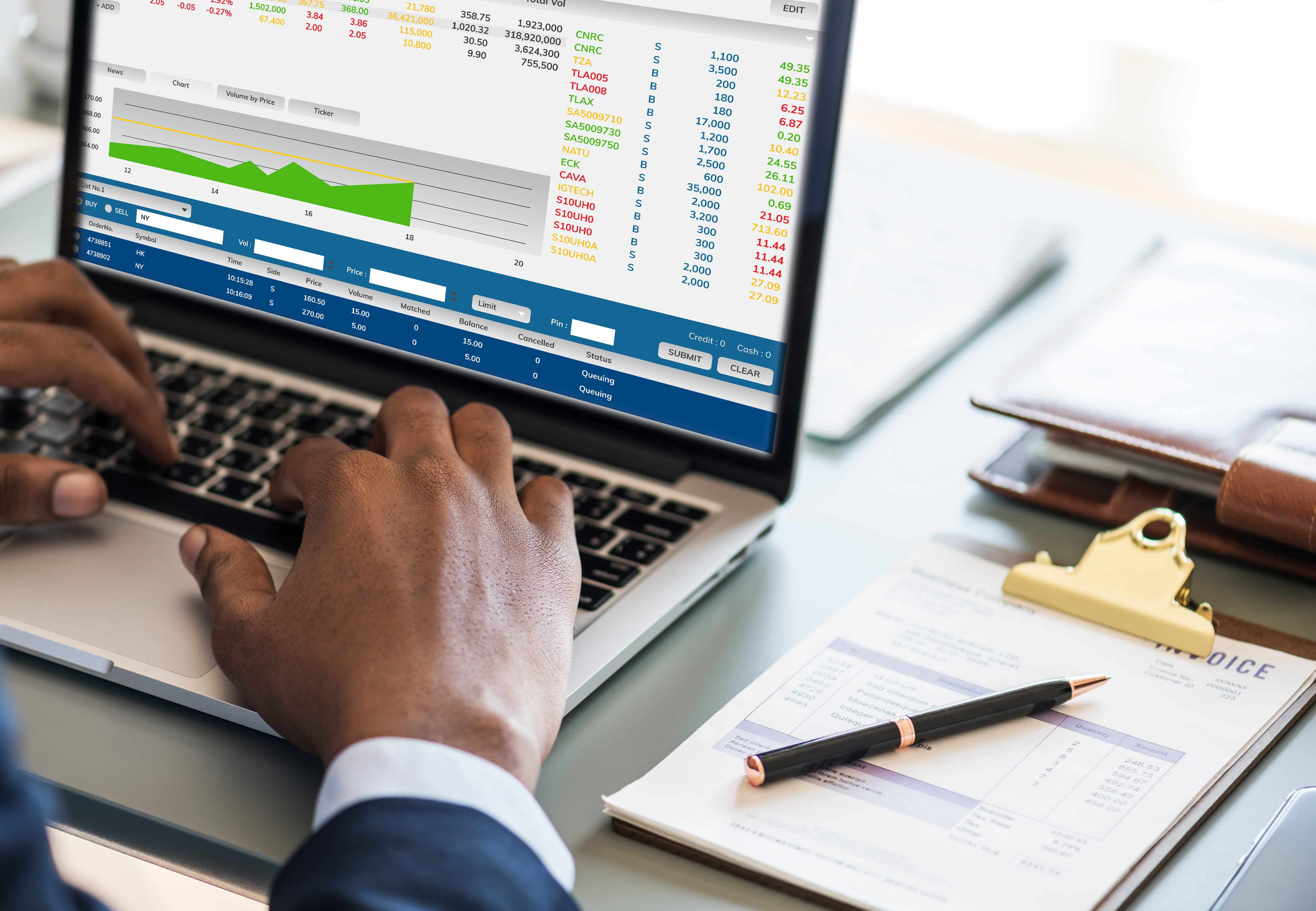 Hands on a laptop showing a business dashboard